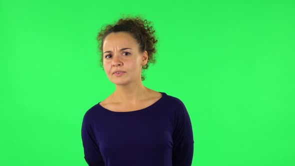 Portrait of Curly Woman Standing in Front of the Camera, Saying Oh My God and Being Shocked. Green