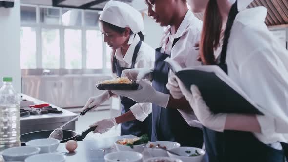 Group of schoolgirls having fun learning to cook. Female students in a cooking class.