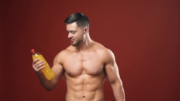 Healthy drink choices. Handsome man with sporty naked body chooses mineral water