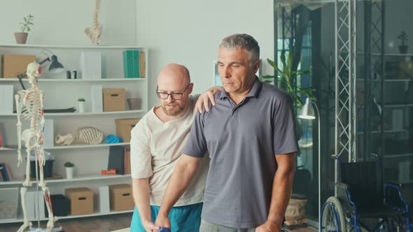 Man a Brain Stroke Doing Dumbbell Exercises As Part of a Rehabilitation Program