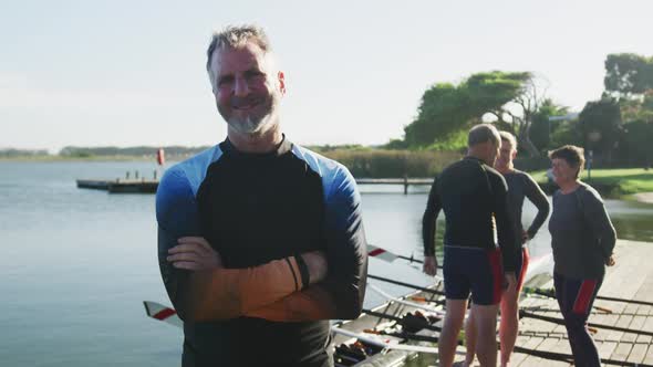 Portrait of senior caucasian man and teammates in background