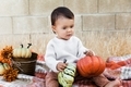 Baby girl holding pumpkins in hands, Autumn harvest  - PhotoDune Item for Sale