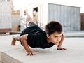 Sporty boy doing exercises in the backyard, fitness at home concept  - PhotoDune Item for Sale