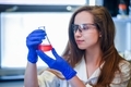 Female student working in a chemistry lab wearing PPE - PhotoDune Item for Sale