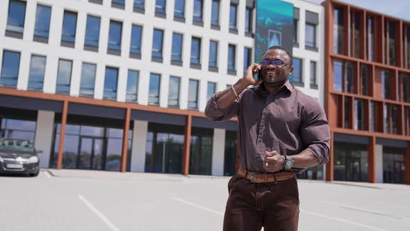 Handsome young businessman communicating on smartphone outdoor