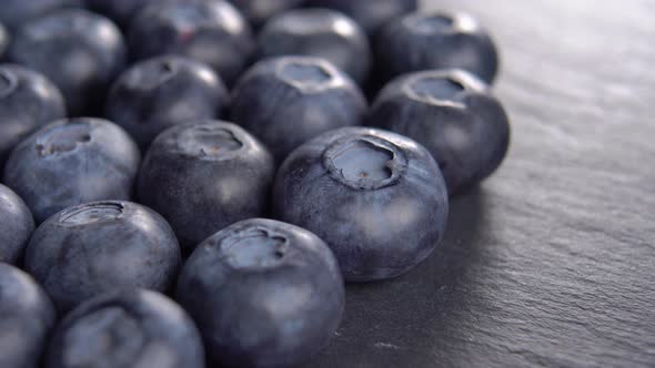 Blueberries on a black kitchen slate stone. Harvest concept. Macro