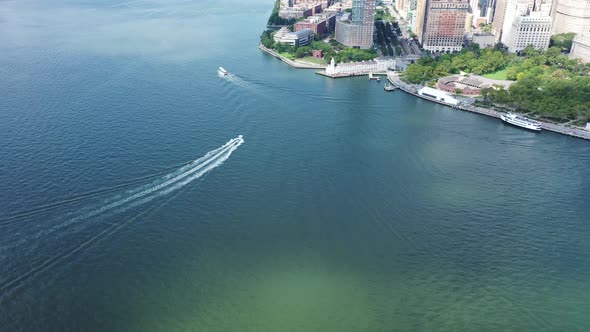 An aerial view looking down over Upper Bay with two boats in the water. The drone dolly in and tilts