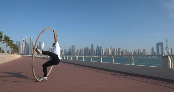 Beautiful View on the City of Dubai in the Background of a Wheel Gymnast