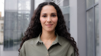 ial multiethnic Caucasian Latina Hispanic beautiful businessperson elegant 30s smiling woman looking at camera. Career people lade close up outside. High quality 4k footage