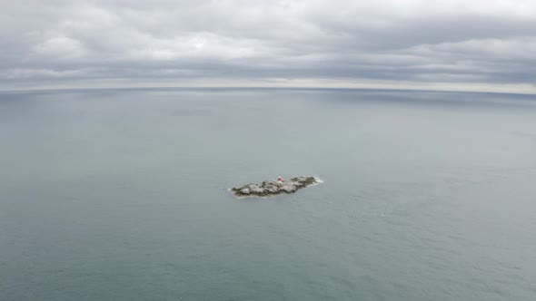 Aerial capture of The Muglins Lighthouse during a cloudy day