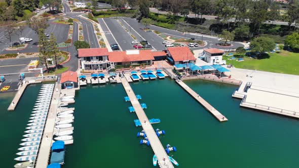 Aerial fly over of the docks with blue boats on community lake mission viejo