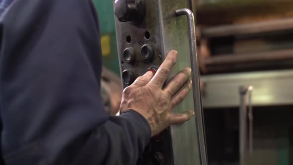 Factory Production Site Close Up at the Production Worker's Hand Pushing Button While Working with