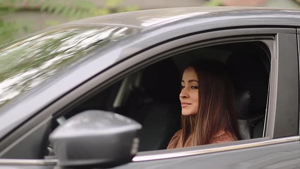 Young woman in car. Auto as present or gift at birthday