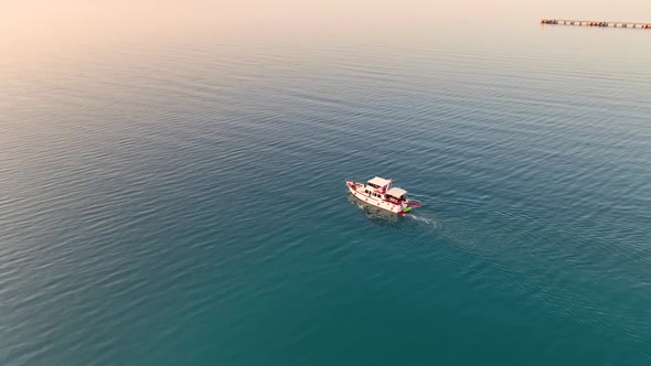 Sunrise Fishing boat goeas to sea aerial view Turkey Alanya 4 K