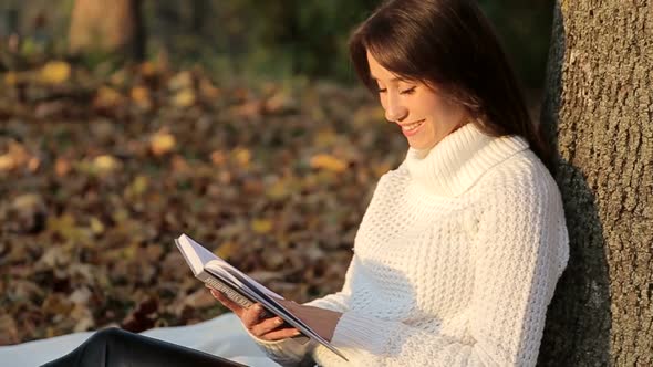 Girl Reading a Book in Park Woman