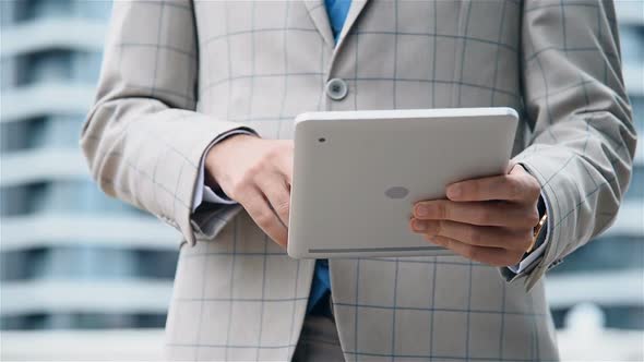 Hands Of Financial Consultant Working On Digital Tablet Outdoor.