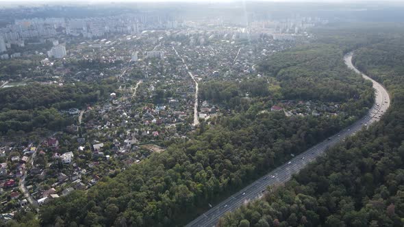 Megalopolis Next To the Forest: the Contact Between the Big City and Nature. Aerial View. Slow