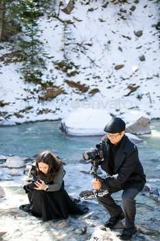 Photographer and videographer on a lake