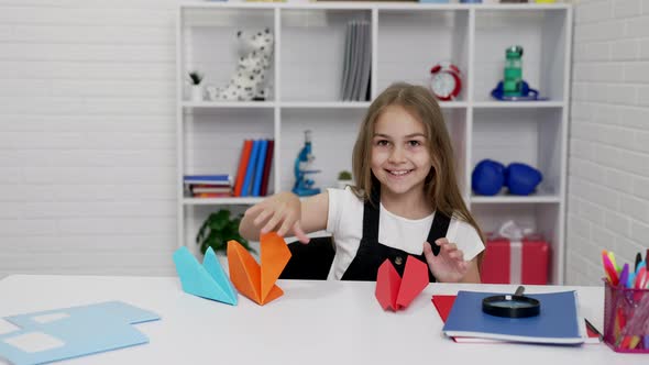 Cheerful Cute Kid Having Fun Playing with Paper Plane in Classroom Playful Mood