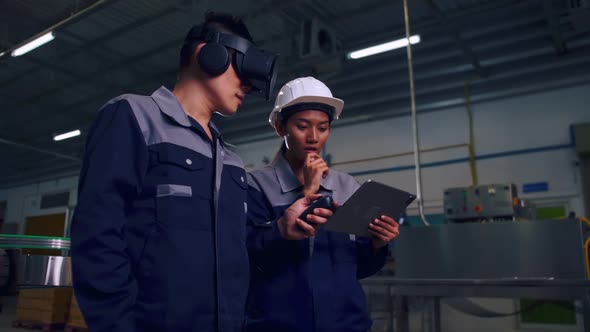 Engineer is using virtual reality glasses to inspect the factory's mechanical control system.