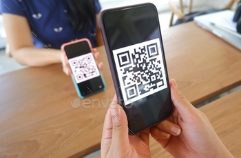 scan QR codes in stores that accept digital payments without money and plastic tags on the table. QR code payment and cashless technology concept.