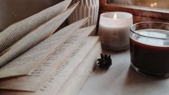 Coffee and book in a morning / open pages / candle light
