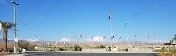 ilitary are proudly displayed along with the American flag. The desert landscape and blue sky are in the background.