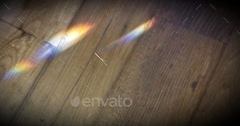 shining through the window, onto a glass table, and then reflecting onto the floor. Light refraction.