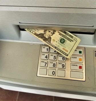 ng ejected from the cash dispenser in an ATM (automated teller machine) banking machine after a person makes a cash withdrawal from their bank account.