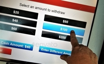 ATM, using the computer screen to select the amount of cash needed.