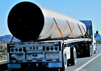  very big pipe on a flat bed trailer on the highway!