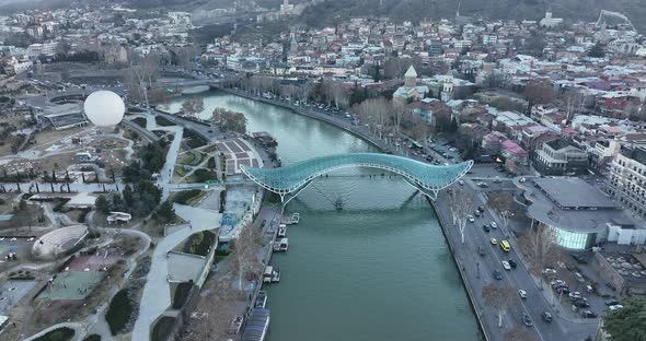 Aerial view of Tbilisi city central park and Bridge of Peace. Beautiful cityscape of old Tbilisi