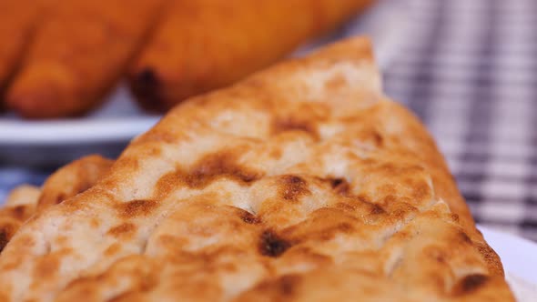 Close Up View Of Fresh Baked Flatbread Piled On Plate On Table