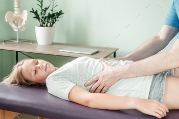 a female patient, rib cage release massage, breathing muscle relaxation