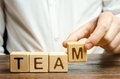 Businessman holds wooden blocks with the word Team - PhotoDune Item for Sale