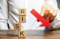 Wooden blocks with the word Risk and a down arrow - PhotoDune Item for Sale