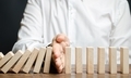 Businessman stops domino falling - PhotoDune Item for Sale