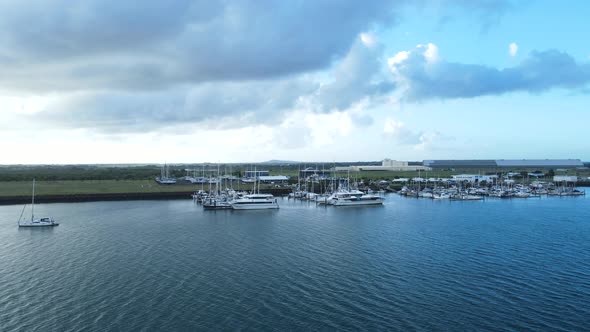 Aing drone view of multiple boats docked in a protected harbor located in the town of Bargara Bundar