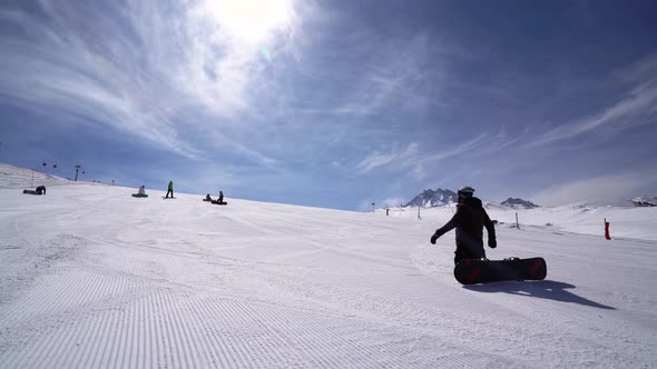 Youngs Snowboarding On Mountains And Sun