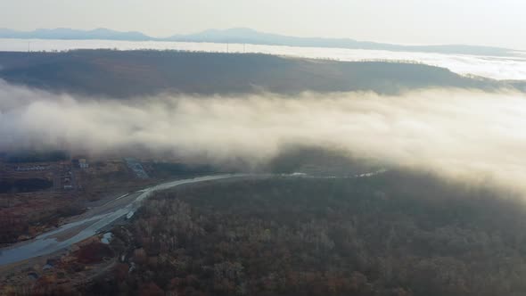 Flight Over the Valley Covered with Morning Mist in the Countryside