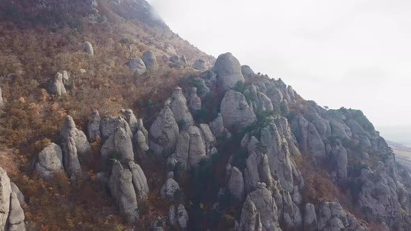 Aerial View of a Drone Flying Over Sharp Rocky Outcrops at Sunset