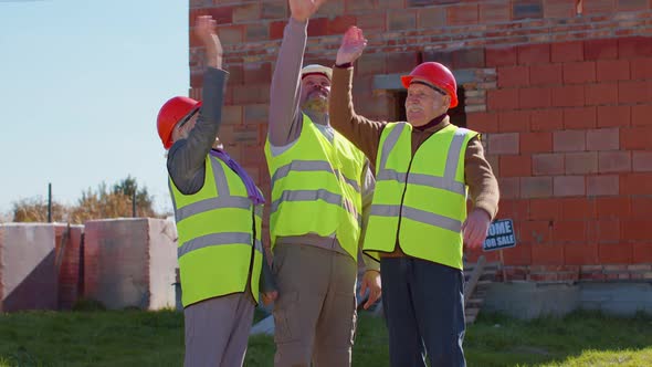 Diverse Team of Specialists Celebrate Success Win Dance Rejoices Doing Winner Gesture Near House