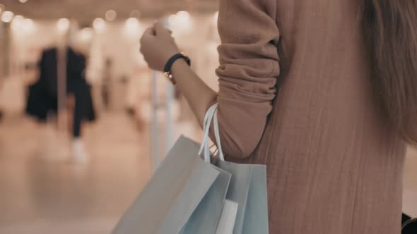 Unrecognizable Woman Walking Towards Clothes Shop