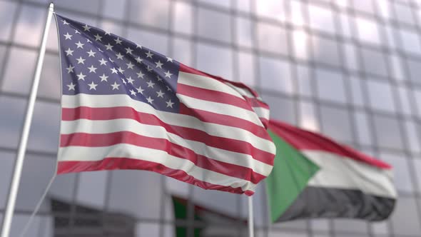 Flags of the USA and Sudan in Front of a Modern Skyscraper