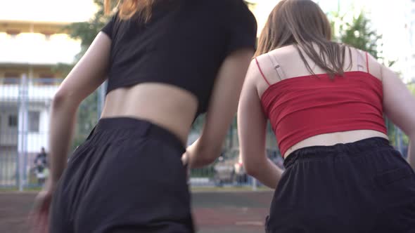 Women Play Basketball Outdoors