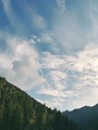 Cloudy day, windy clouds, blue sky, deep forest, mountain valley, sunny day, beautiful nature - PhotoDune Item for Sale