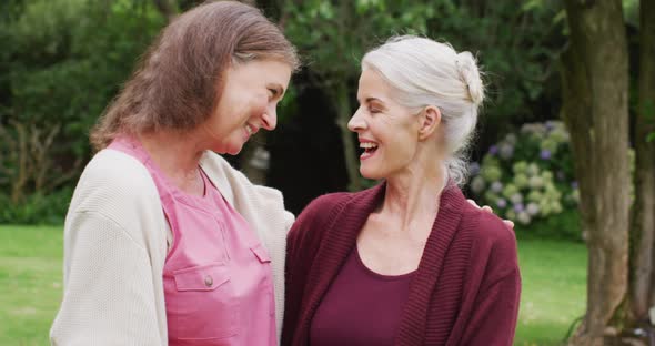 Animation of happy caucasian female senior friends talking in garden