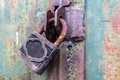 old and rusty padlock with scratches locks the steel doors of an abandoned vault  - PhotoDune Item for Sale