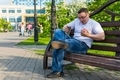 Man sitting on a bench spills coffee on his pants - PhotoDune Item for Sale