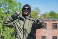 Masked bandit shows threatening gestures with a knife - PhotoDune Item for Sale